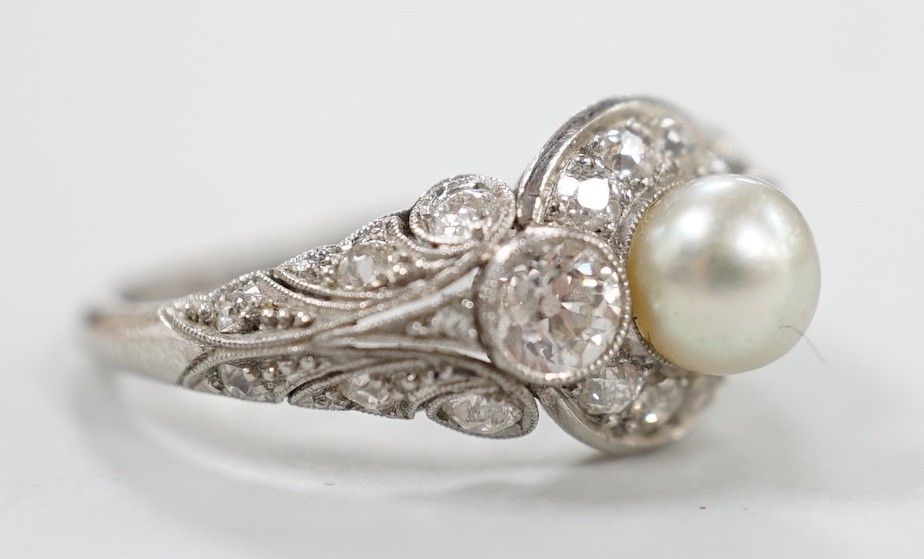 A white metal(stamped Platin), cultured pearl and diamond set circular cluster ring, size M, gross weight 5 grams.